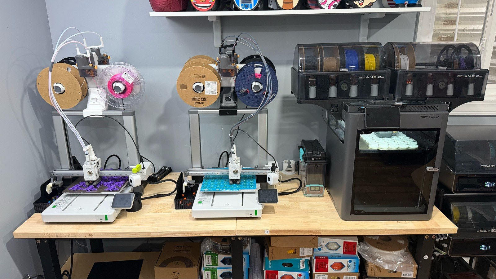 Three Bambu Lab 3D printers producing batches of custom pieces in the Cheherish workshop