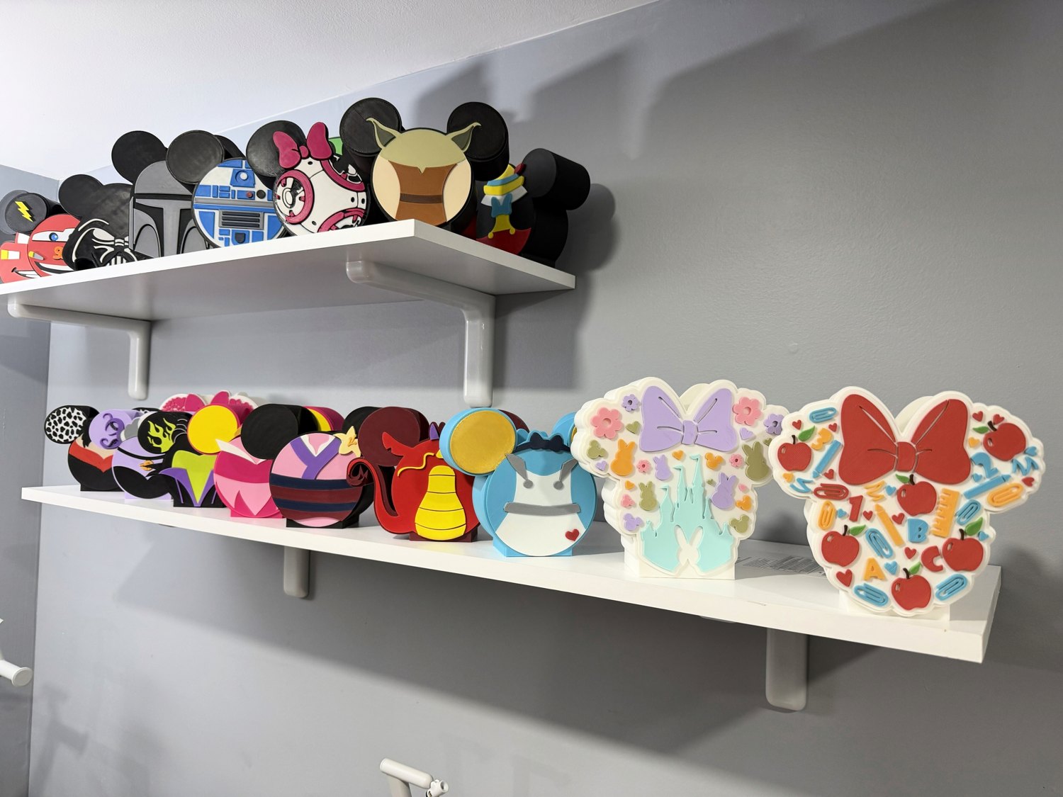 Colorful custom 3D printed pieces displayed on shelves by Cheherish Creations