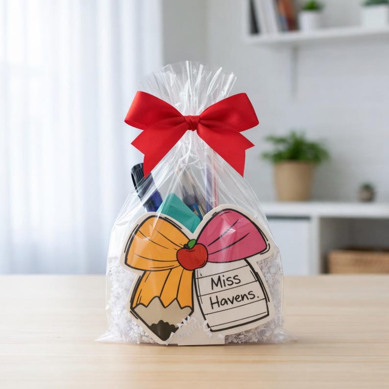 Personalized apple-and-bow teacher desk organizer, styled in gift packaging with a red ribbon